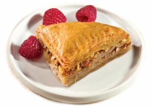 Classic baklava on a plate with three raspberries