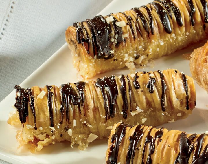 Baklava nut rolls with drizzled sweet syrup on top