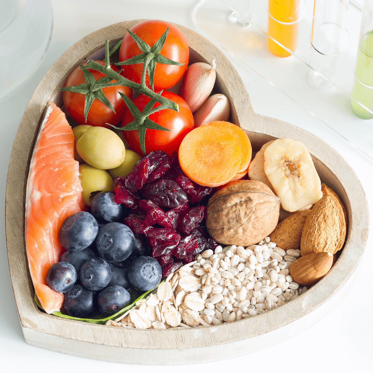 Heart-shaped bowl filled with various healthy foods