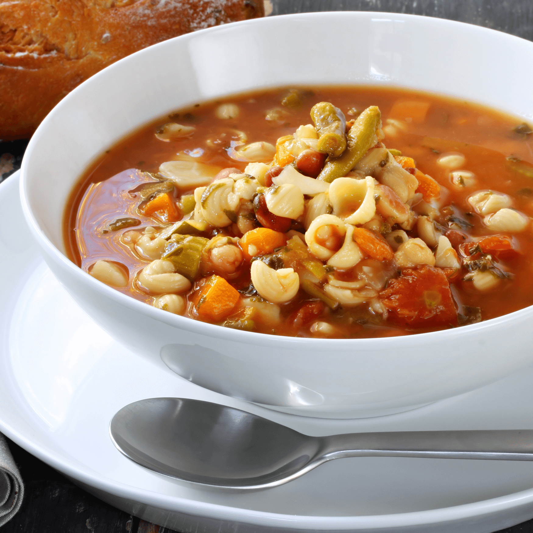 Bowl of minestrone pasta soup on a rustic table