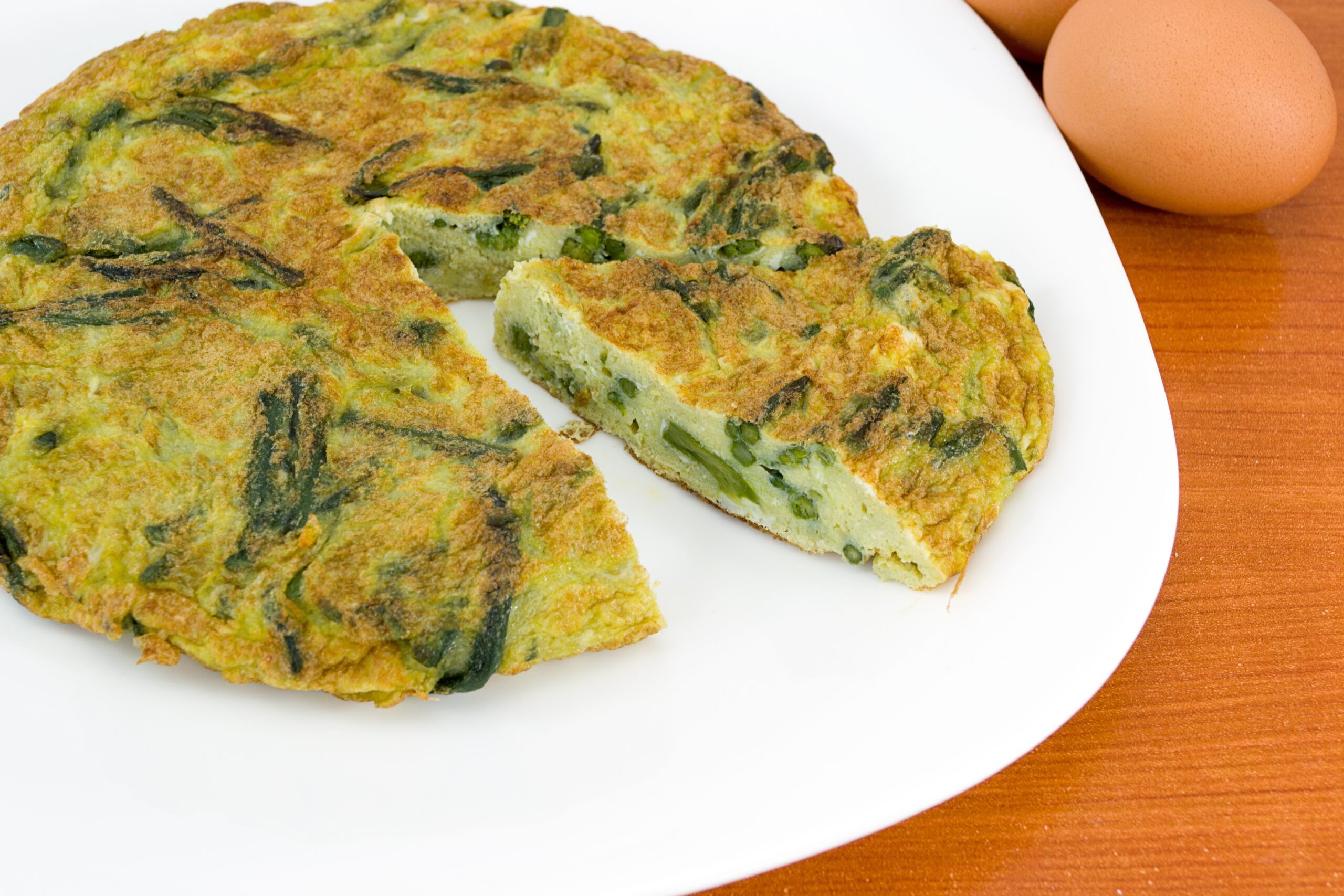 Frittata with asparagus on a white plate