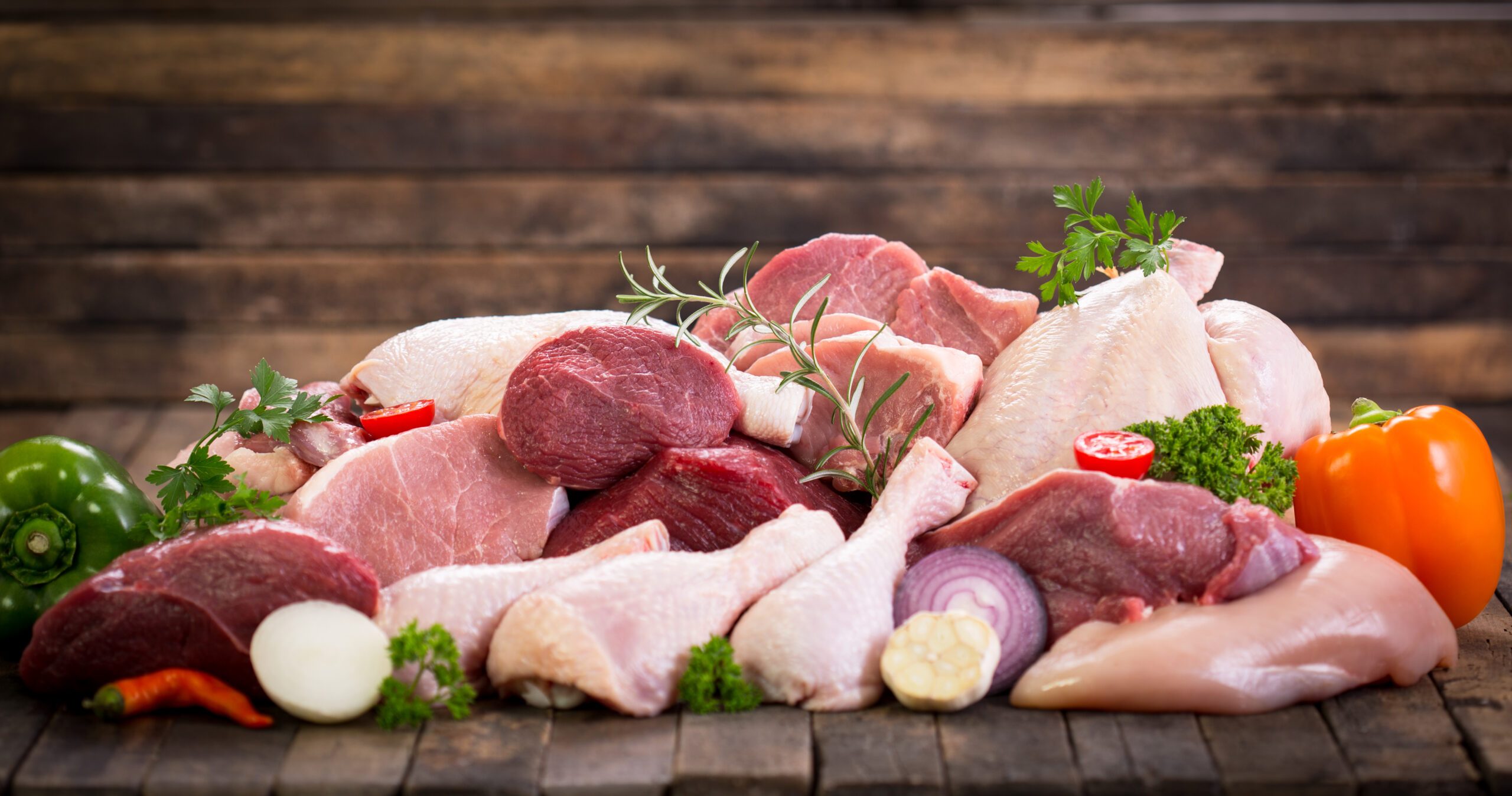 Several different types of raw meat piled together