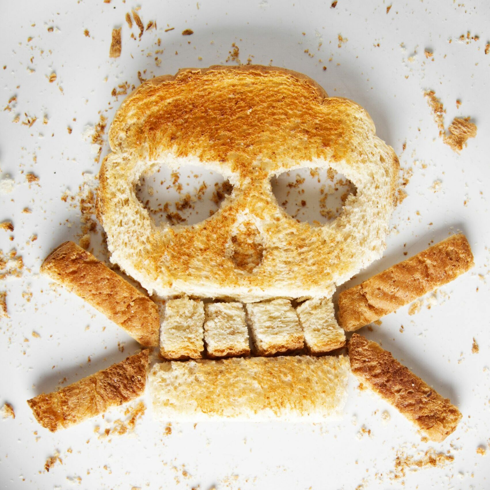 Image of bread skull and crossbones on white plate