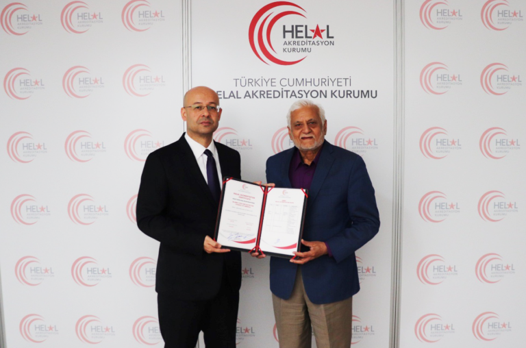 IFANCA President and CEO Muhammad M. Chaudry accepts the IFANCA accreditation certificate from a HAK representative