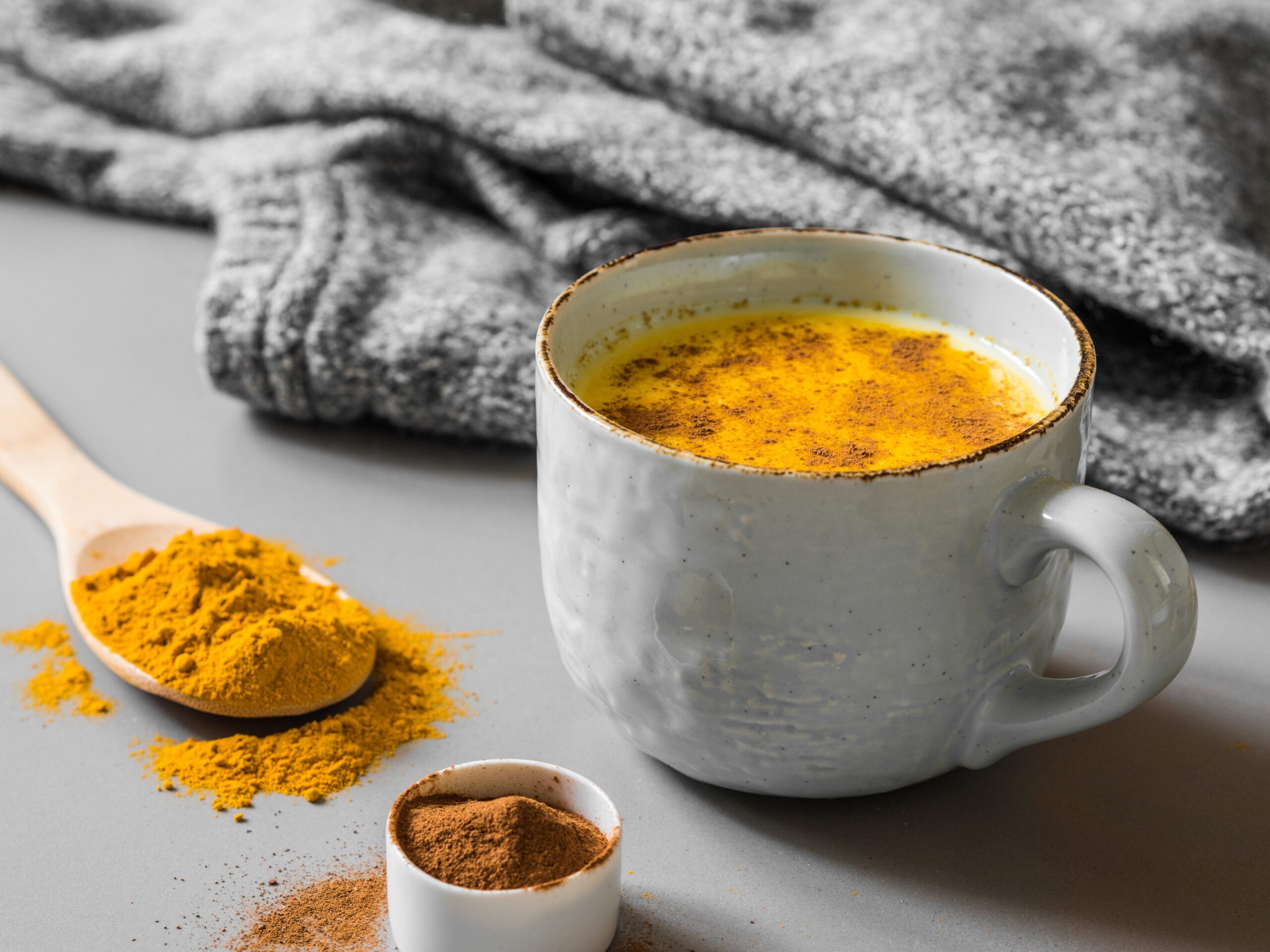 Turmeric latte with milk and cinnamon. Elixir of health and vivacity. Traditional healthy Indian detox drink.
